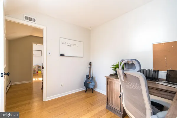 a bedroom with a bed chandelier and a window