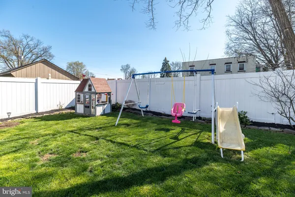 a front view of a house with a yard and outdoor seating