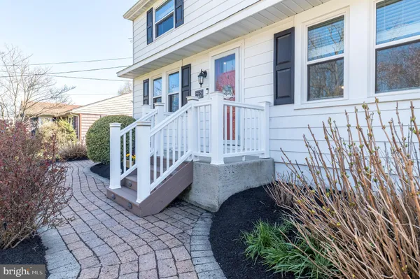 a view of front door of house with stairs