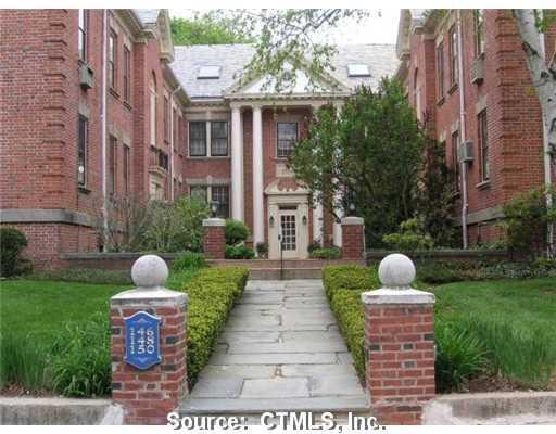 a front view of a house with garden and yard