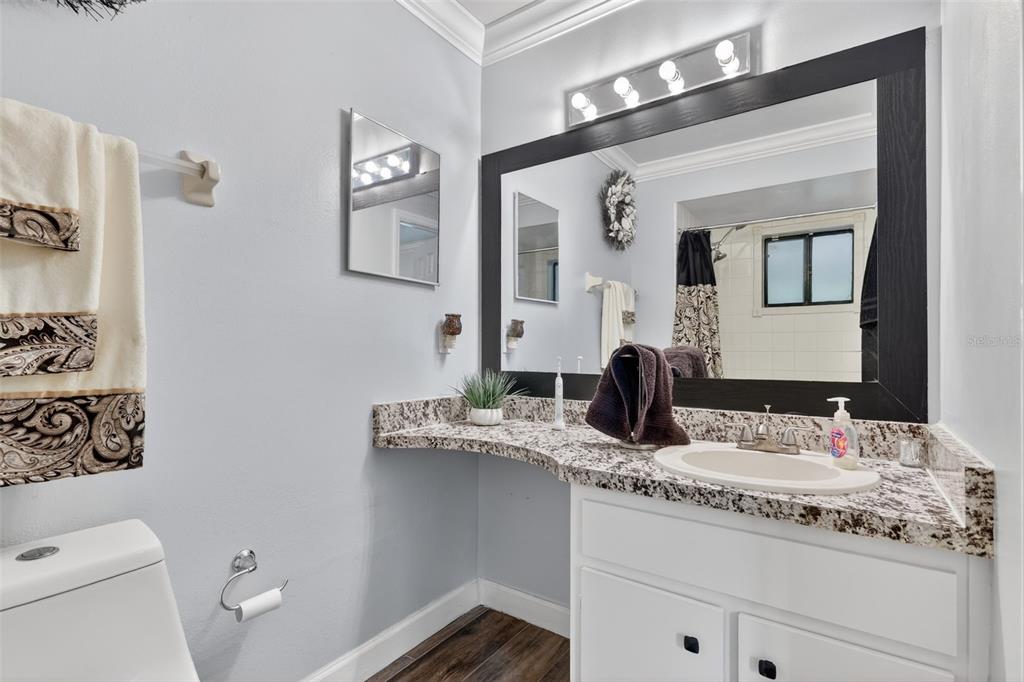 575 Tiberon Cove Road Longwood, FL 32750 - Photo 34 of 56 a bathroom with a granite countertop toilet sink and mirror