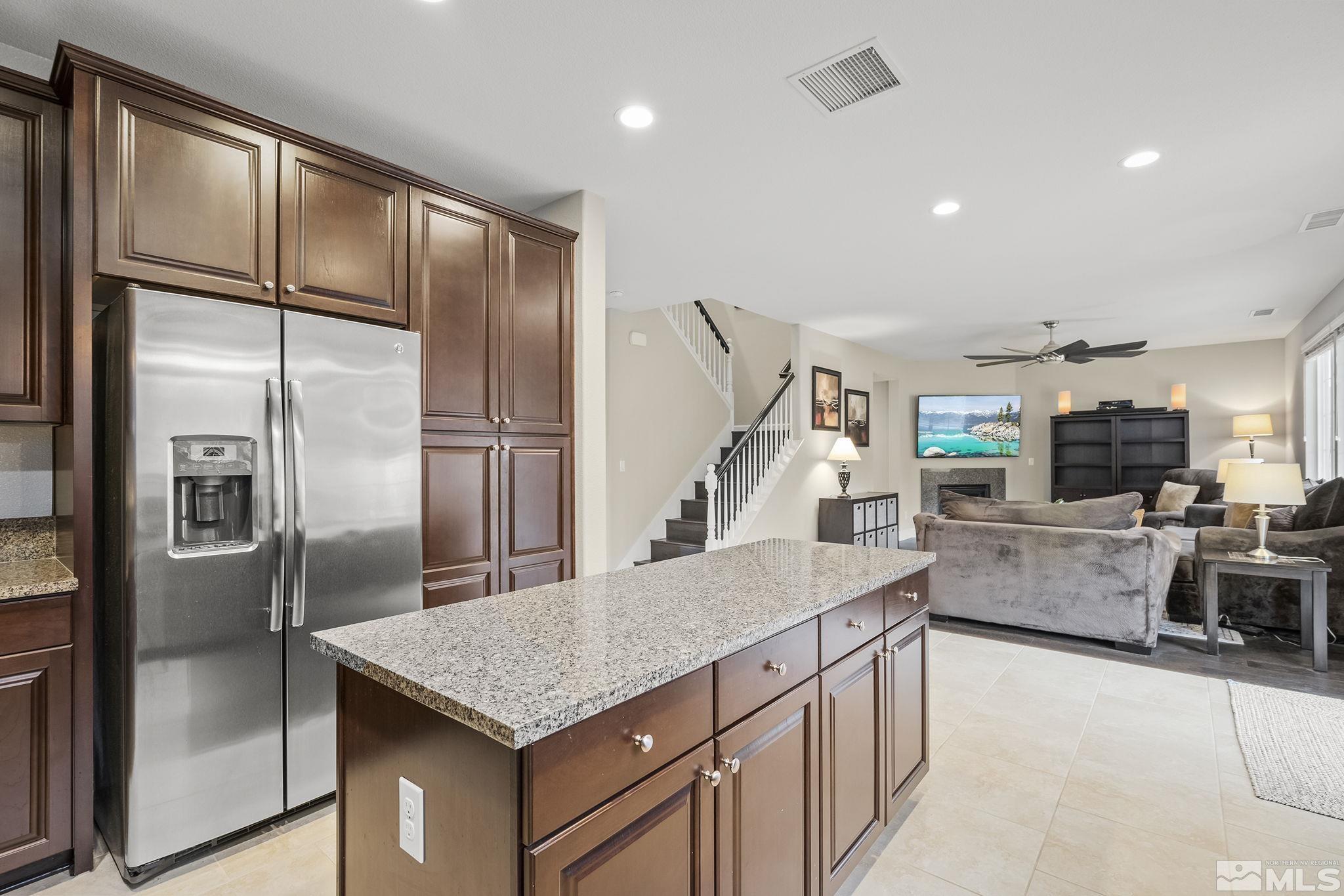 10848 Walnut Ridge Drive Reno, NV 89521 - Photo 12 of 32 a kitchen with stainless steel appliances granite countertop a refrigerator a stove and a sink