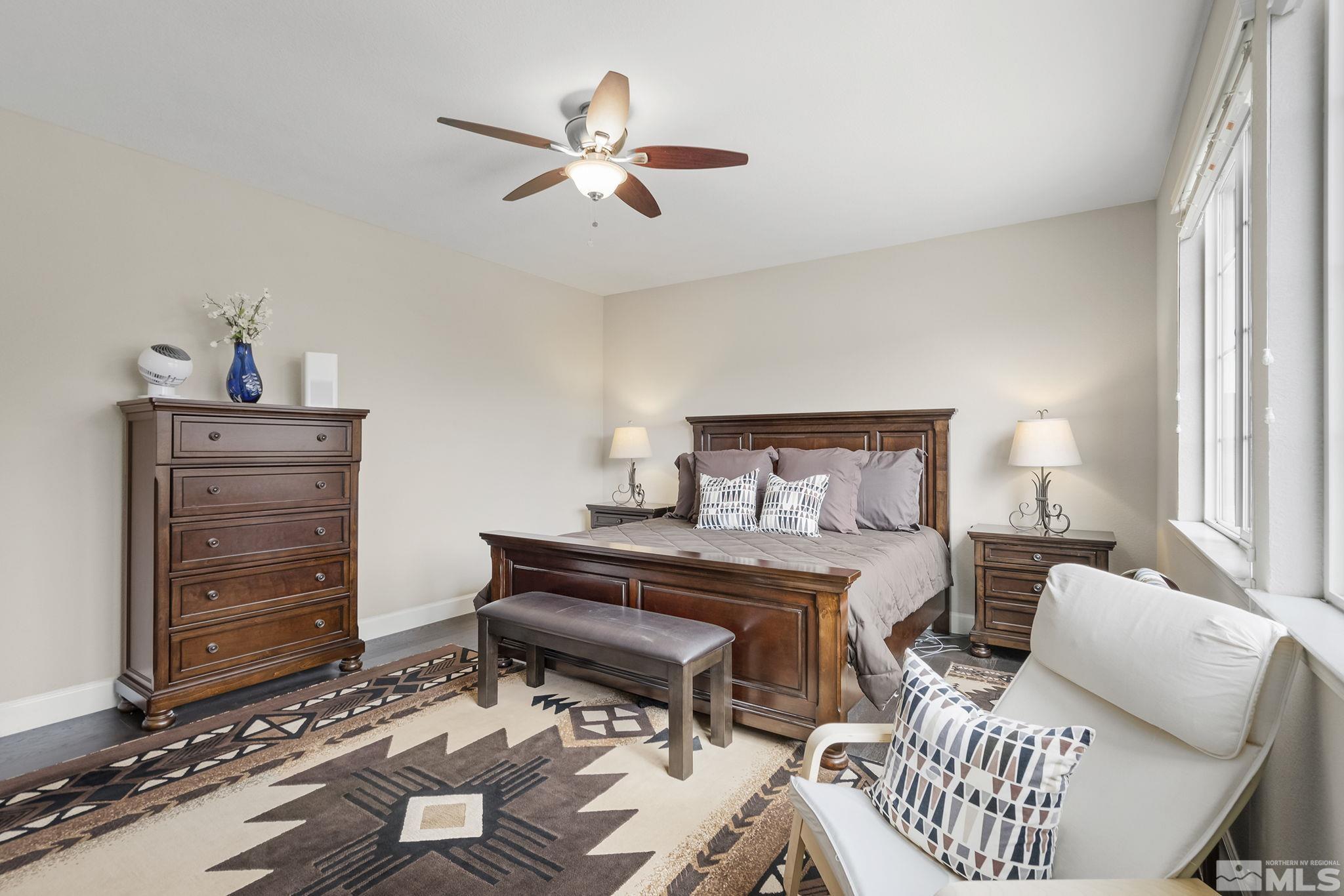 10848 Walnut Ridge Drive Reno, NV 89521 - Photo 15 of 32 a bedroom with a bed and a chandelier