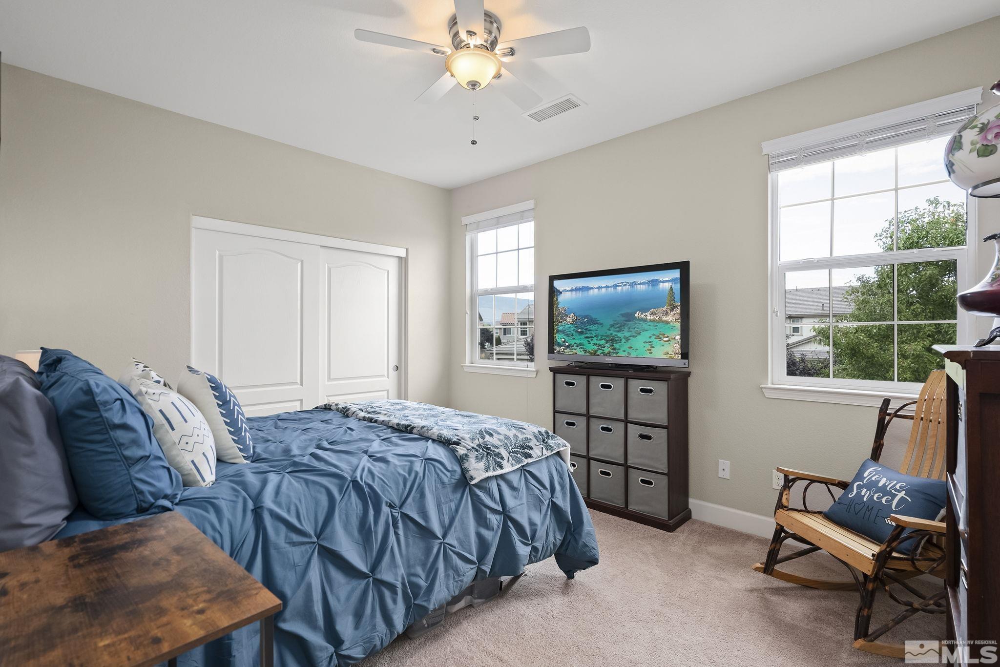 10848 Walnut Ridge Drive Reno, NV 89521 - Photo 20 of 32 a bedroom with a bed and a flat screen tv