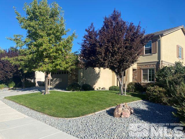 10848 Walnut Ridge Drive Reno, NV 89521 - Photo 2 of 32 a house with huge green field in front of it