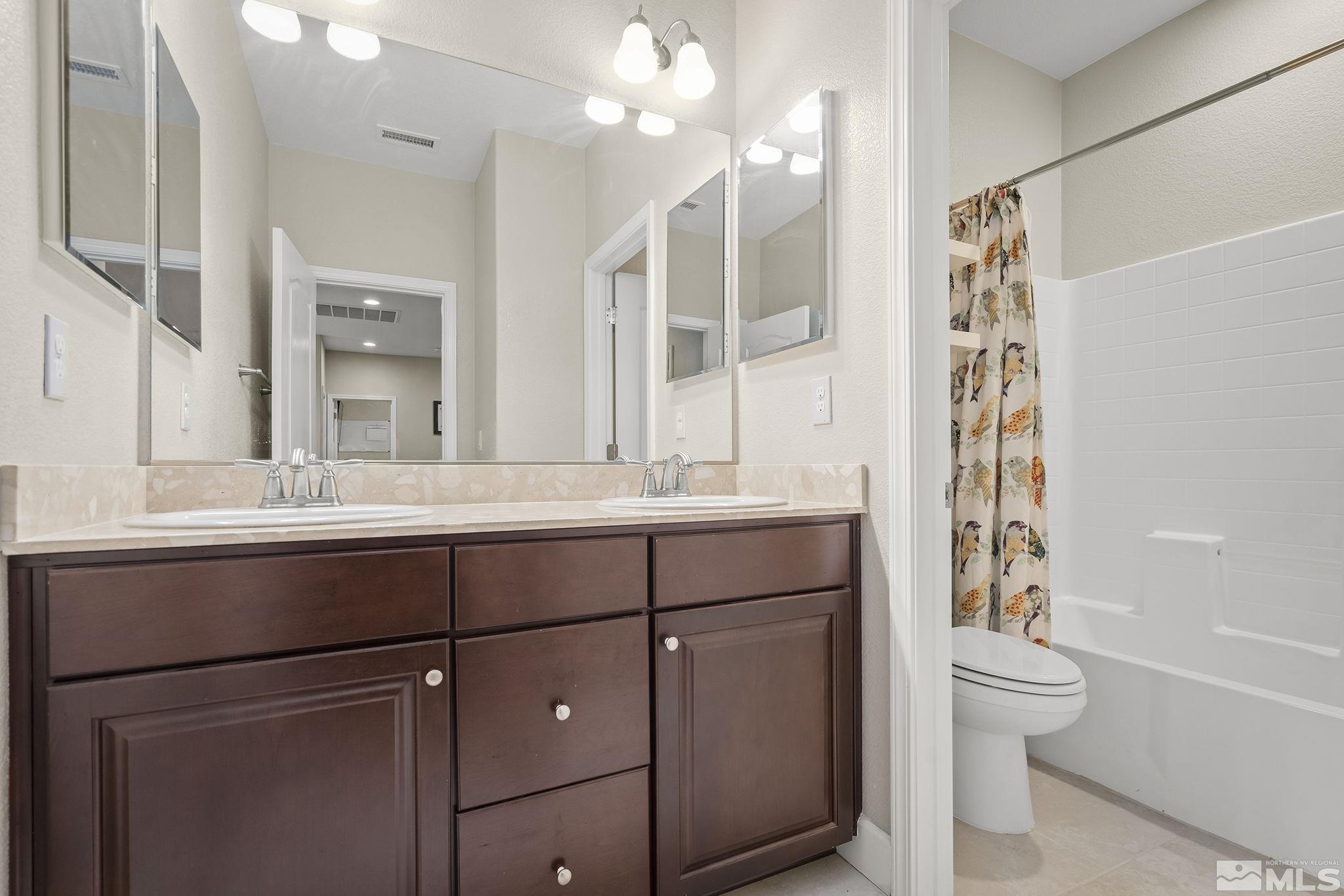 10848 Walnut Ridge Drive Reno, NV 89521 - Photo 23 of 32 a bathroom with a sink a toilet and shower