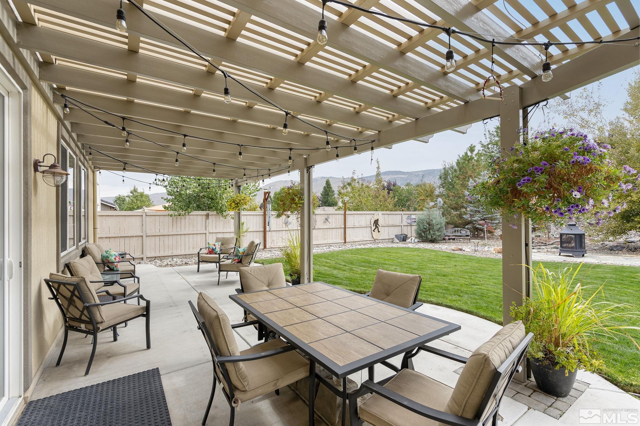 10848 Walnut Ridge Drive Reno, NV 89521 - Photo 25 of 32 a view of a patio with a table chairs and a backyard