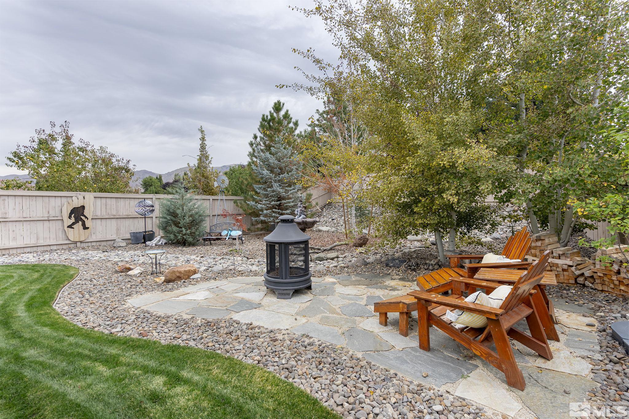 10848 Walnut Ridge Drive Reno, NV 89521 - Photo 26 of 32 a backyard of a house with table and chairs