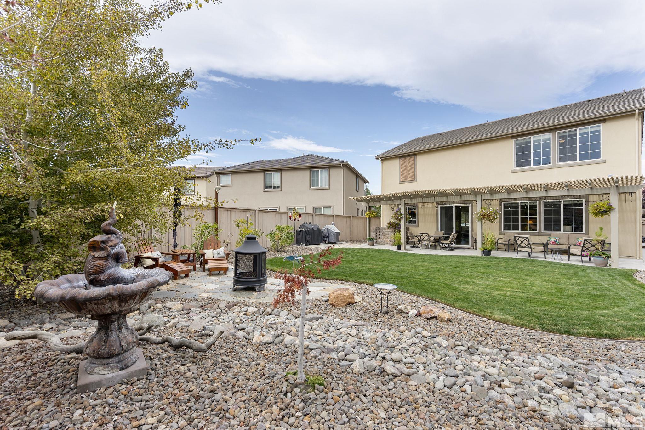 10848 Walnut Ridge Drive Reno, NV 89521 - Photo 28 of 32 a view of a house with backyard sitting area and garden