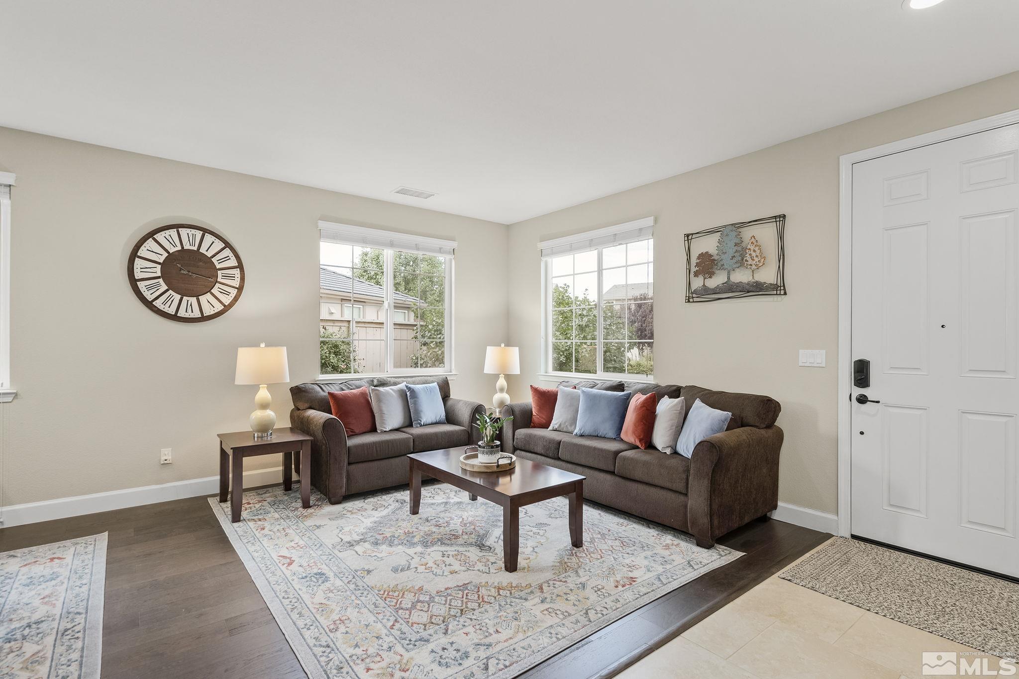 10848 Walnut Ridge Drive Reno, NV 89521 - Photo 4 of 32 a living room with furniture a window and a clock