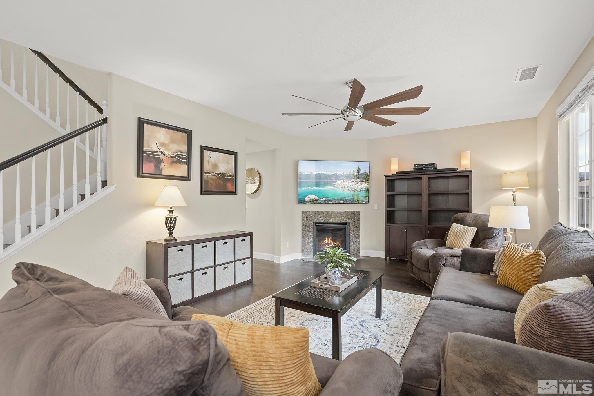 10848 Walnut Ridge Drive Reno, NV 89521 - Photo 8 of 32 a living room with furniture a rug and a ceiling fan