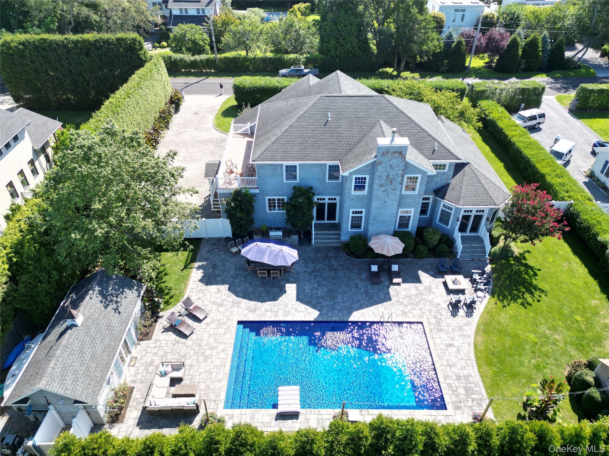 43 Shore Road Remsenburg, NY 11960 - Photo 1 of 28 a aerial view of a house with table and chairs