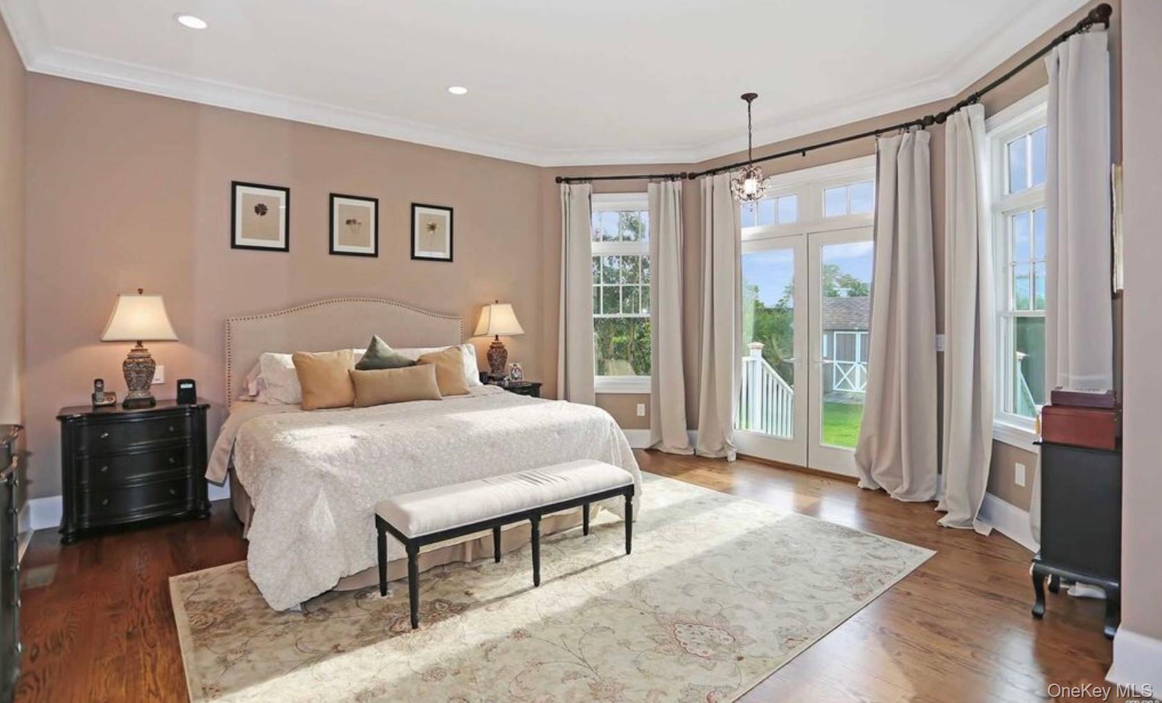 43 Shore Road Remsenburg, NY 11960 - Photo 14 of 28 a bedroom with a bed and wooden floor