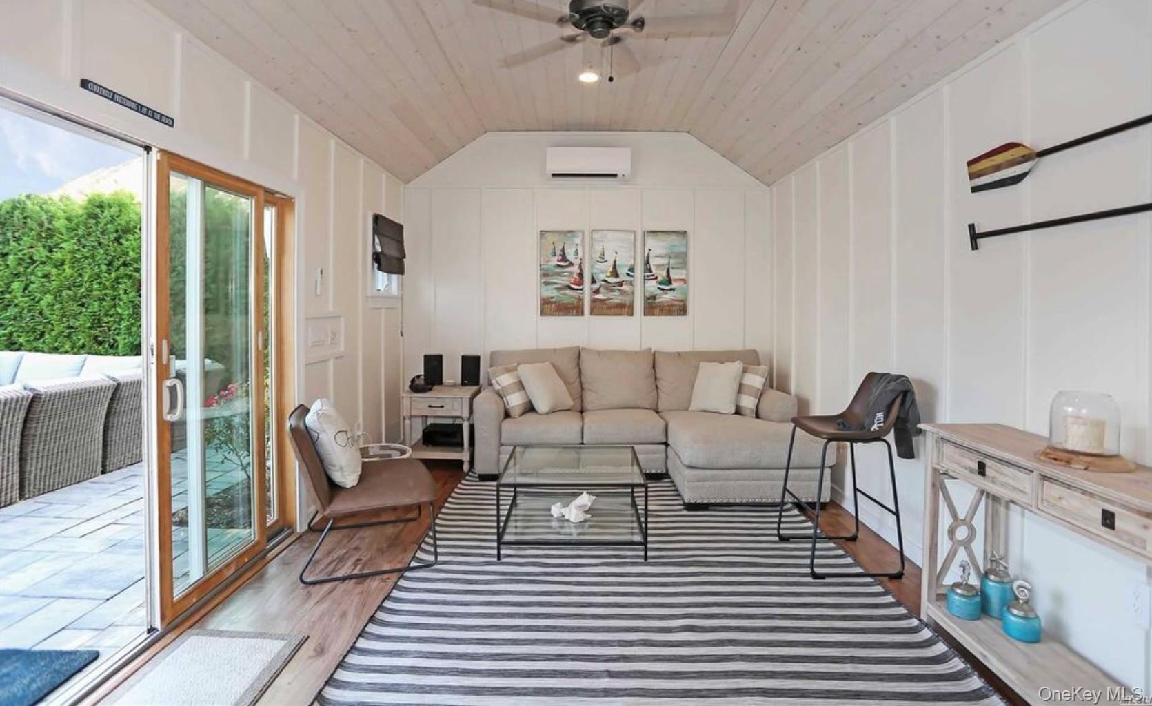 43 Shore Road Remsenburg, NY 11960 - Photo 18 of 28 a living room with furniture and a rug