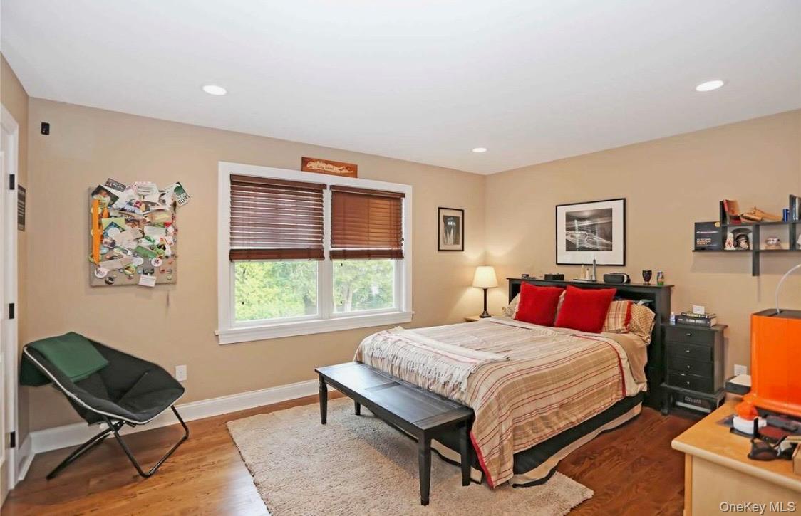 43 Shore Road Remsenburg, NY 11960 - Photo 19 of 28 a bedroom with a bed a chair and a large window