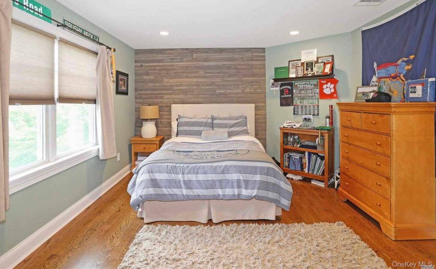 43 Shore Road Remsenburg, NY 11960 - Photo 26 of 28 a bedroom with a bed and wooden floor