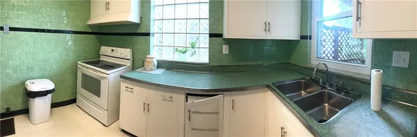 a kitchen with a sink appliances and cabinets