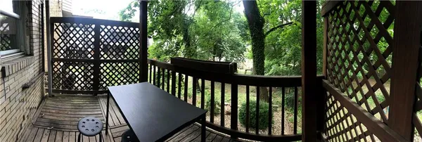 a view of a balcony with wooden floor