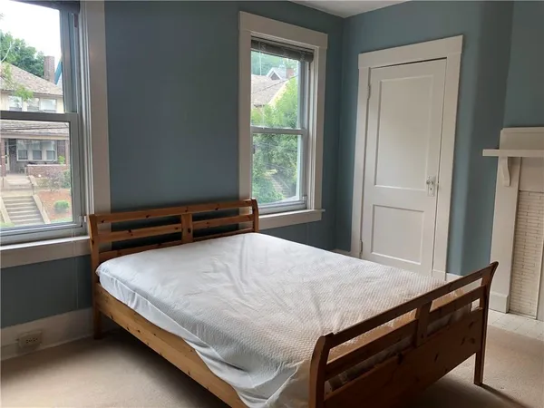 a view of a room that has a bed and a window