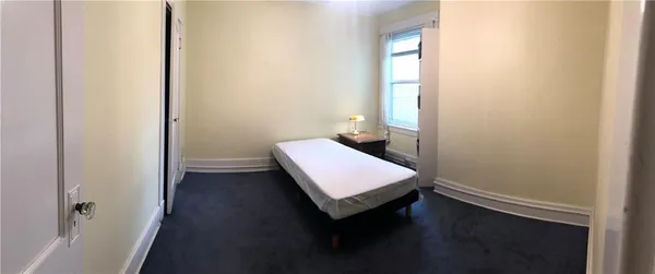 a room with a window and wooden floor