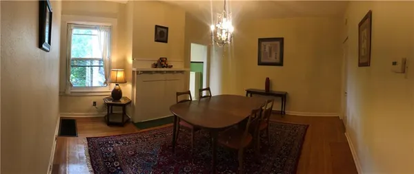 a dining room with furniture and window