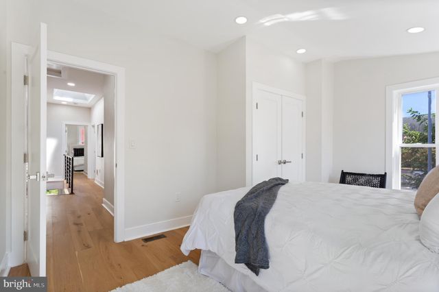 a bedroom with a bed and a wooden floor