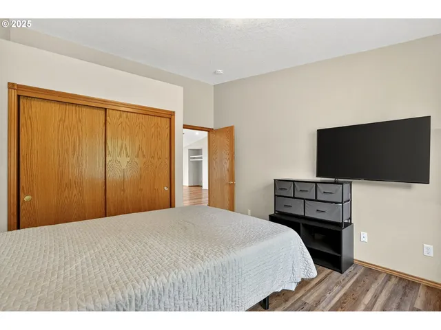 a bedroom with a bed and a flat screen tv