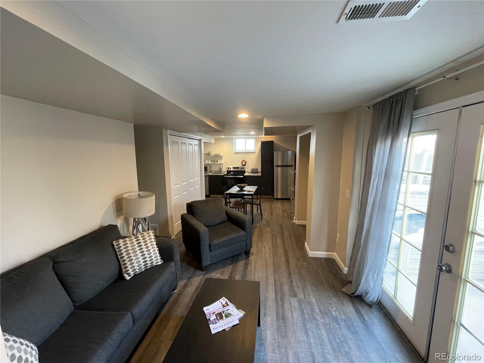 1671 North State Highway 83, Unit B Franktown, CO 80116 - Photo 12 of 21 a living room with furniture and a wooden floor