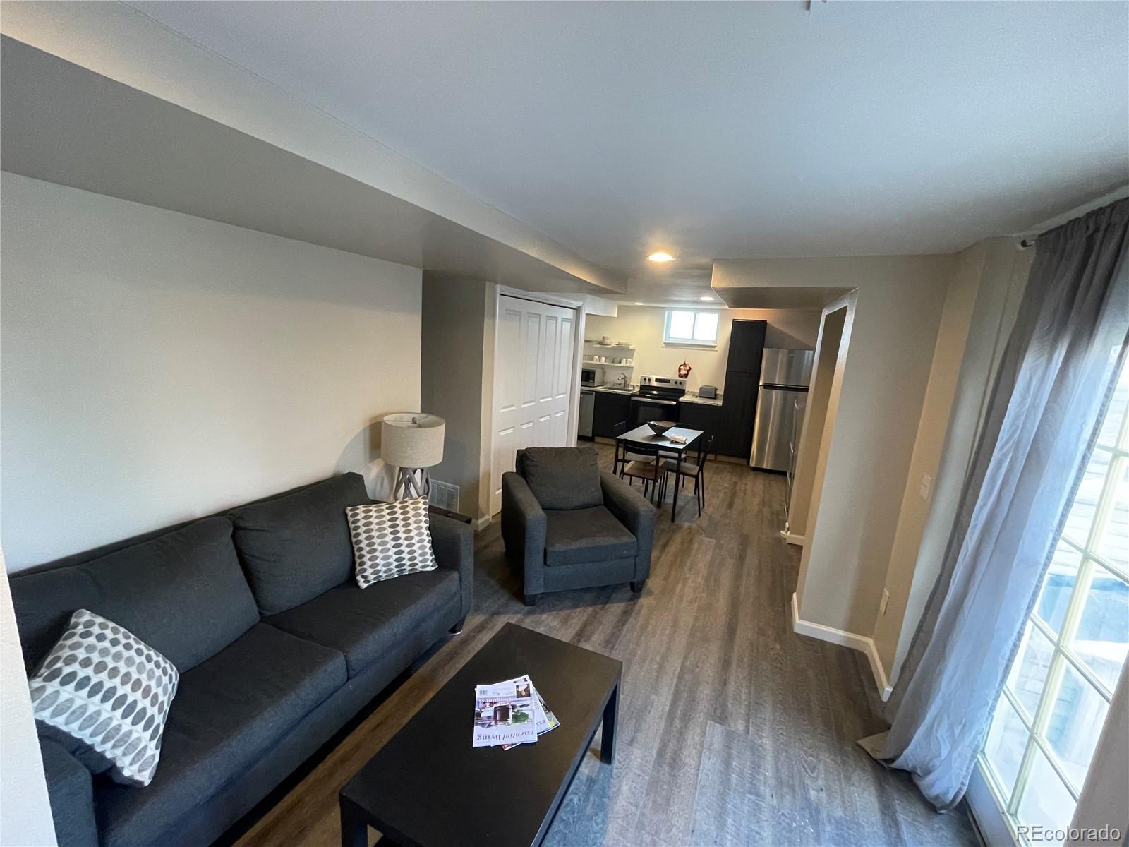 1671 North State Highway 83, Unit B Franktown, CO 80116 - Photo 13 of 21 a living room with furniture and a wooden floor