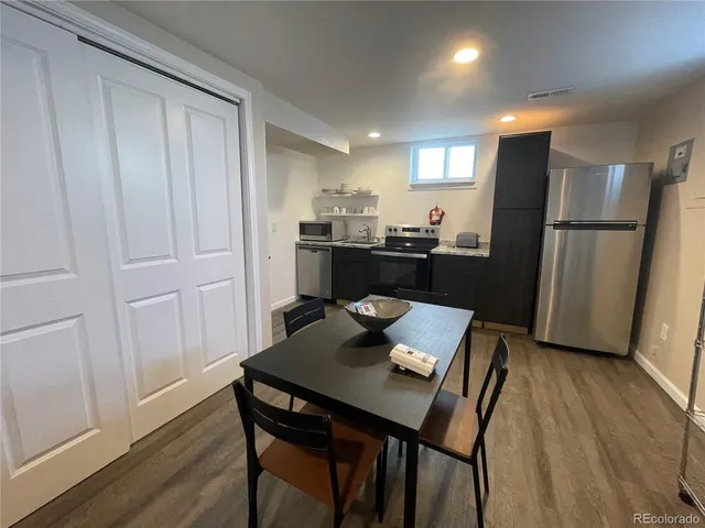 a view of a dining room with furniture and wooden floor