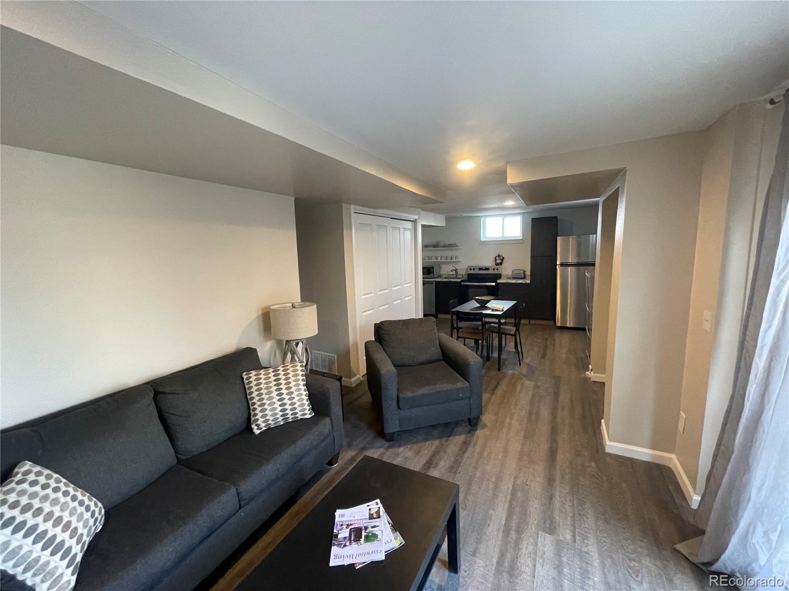 1671 North State Highway 83, Unit B Franktown, CO 80116 - Photo 15 of 21 a living room with furniture and a wooden floor
