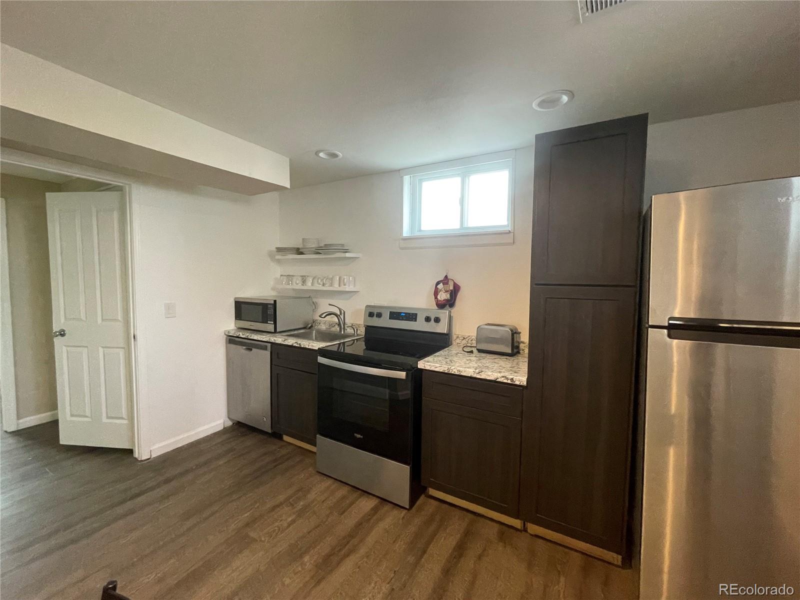 1671 North State Highway 83, Unit B Franktown, CO 80116 - Photo 16 of 21 a kitchen with granite countertop a refrigerator stove and sink