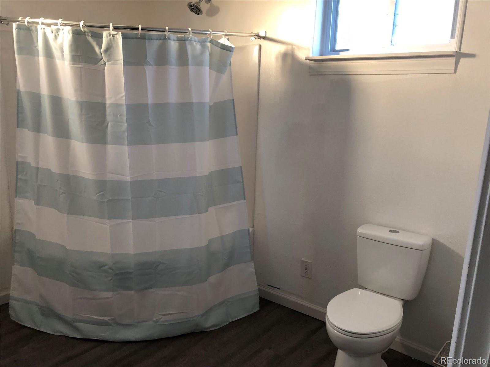 1671 North State Highway 83, Unit B Franktown, CO 80116 - Photo 4 of 21 a bathroom with a toilet and a shower