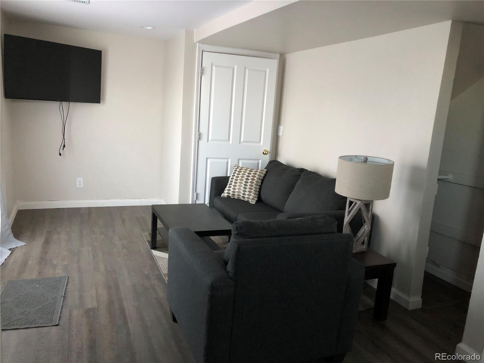 1671 North State Highway 83, Unit B Franktown, CO 80116 - Photo 7 of 21 a living room with furniture and a flat screen tv