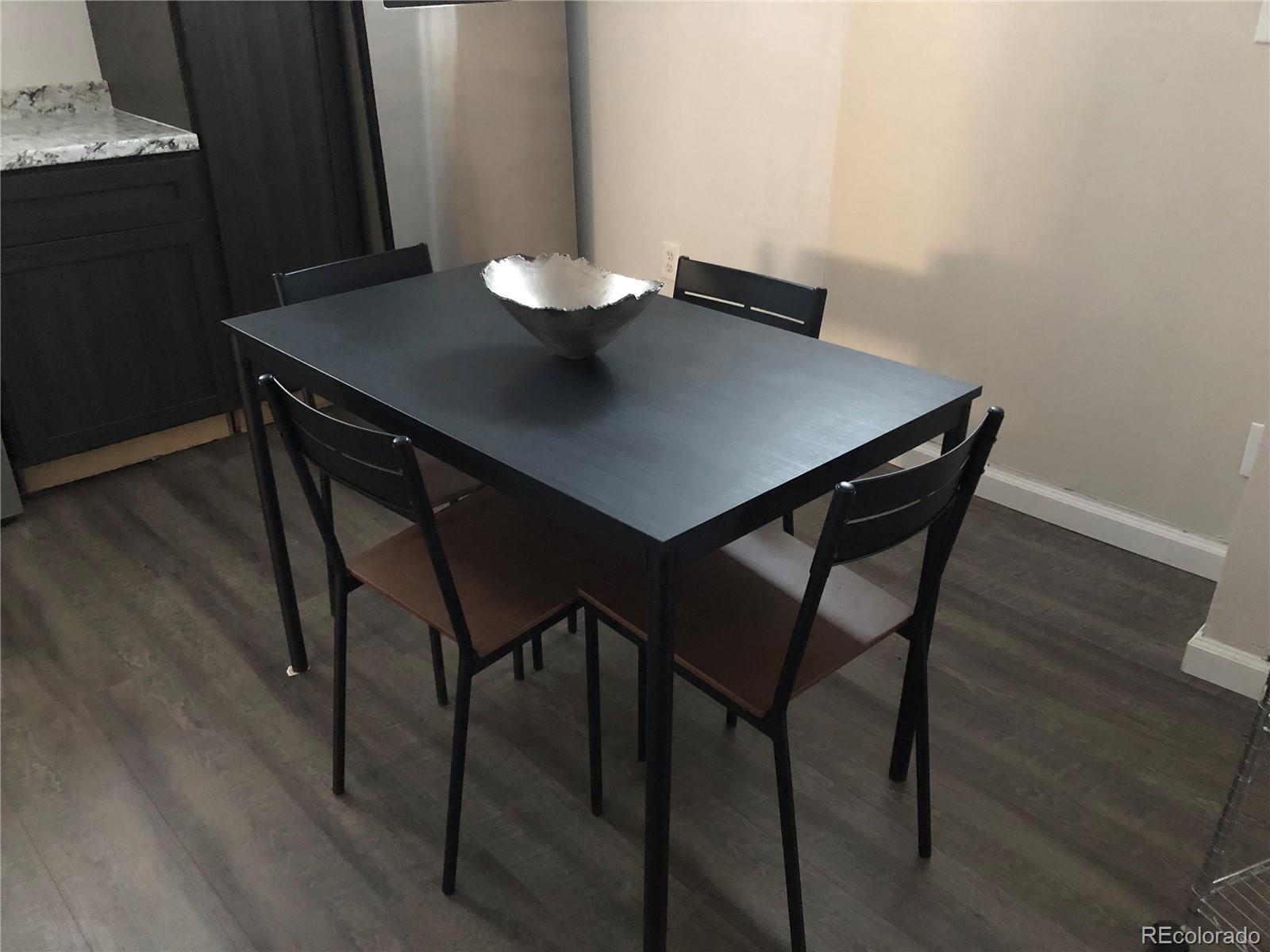 1671 North State Highway 83, Unit B Franktown, CO 80116 - Photo 10 of 21 a view of a dining room with furniture and wooden floor