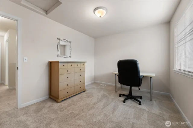 a view of a workspace with furniture