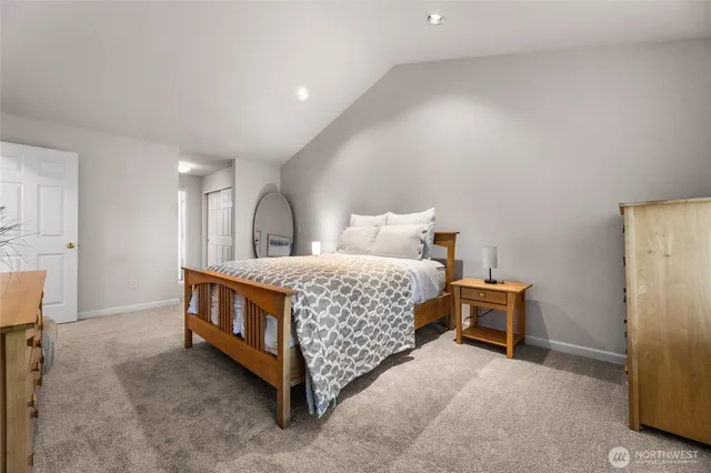 a bed room with a bed and a chair