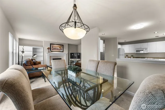 a living room with furniture a dining table and chairs