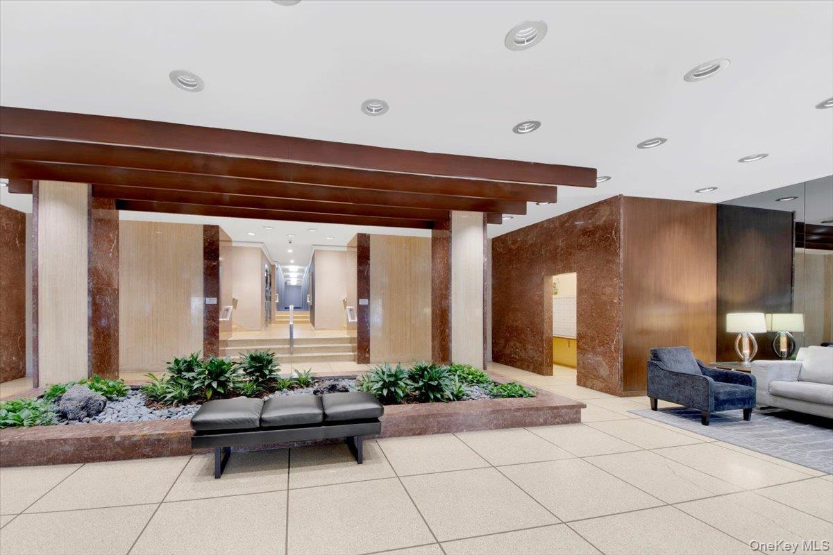 3777 Independence Avenue, Unit 16F Bronx, NY 10463 - Photo 6 of 27 a living room with furniture and potted plants