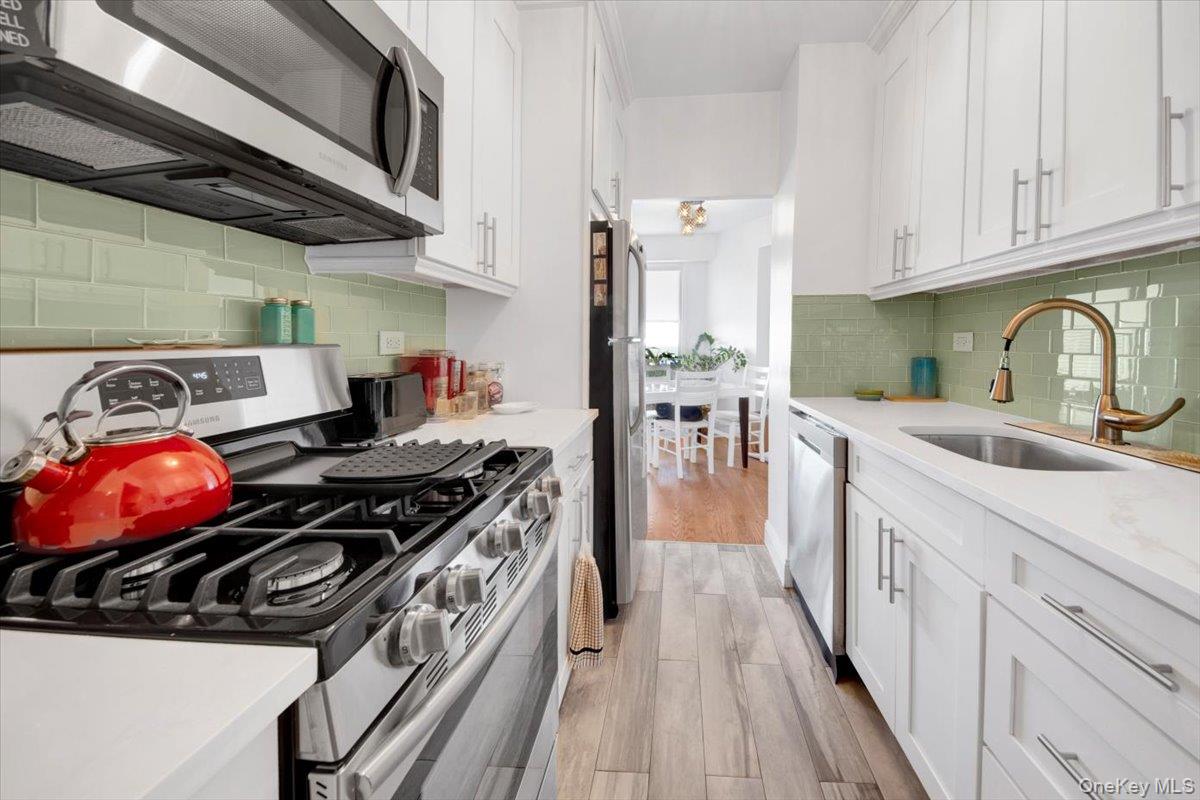 3777 Independence Avenue, Unit 16F Bronx, NY 10463 - Photo 8 of 27 a kitchen with a stove a sink and dishwasher