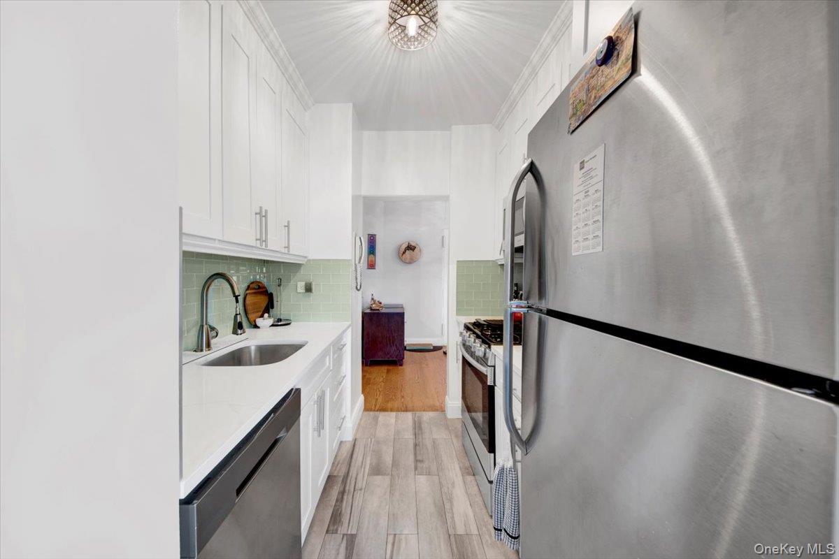 3777 Independence Avenue, Unit 16F Bronx, NY 10463 - Photo 9 of 27 a kitchen with a sink a refrigerator and a stove