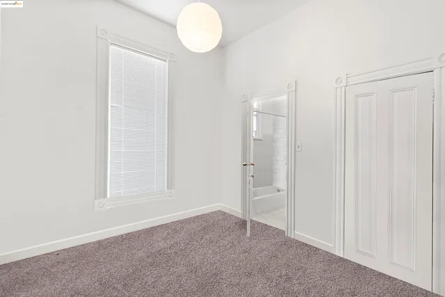 a view of an empty room and wooden floor