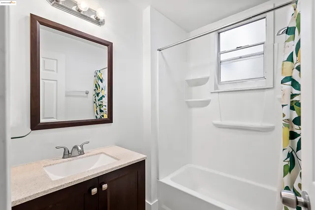 a bathroom with a bathtub a sink and a mirror