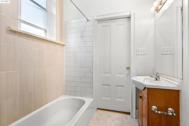 a bathroom with a tub a sink and a shower