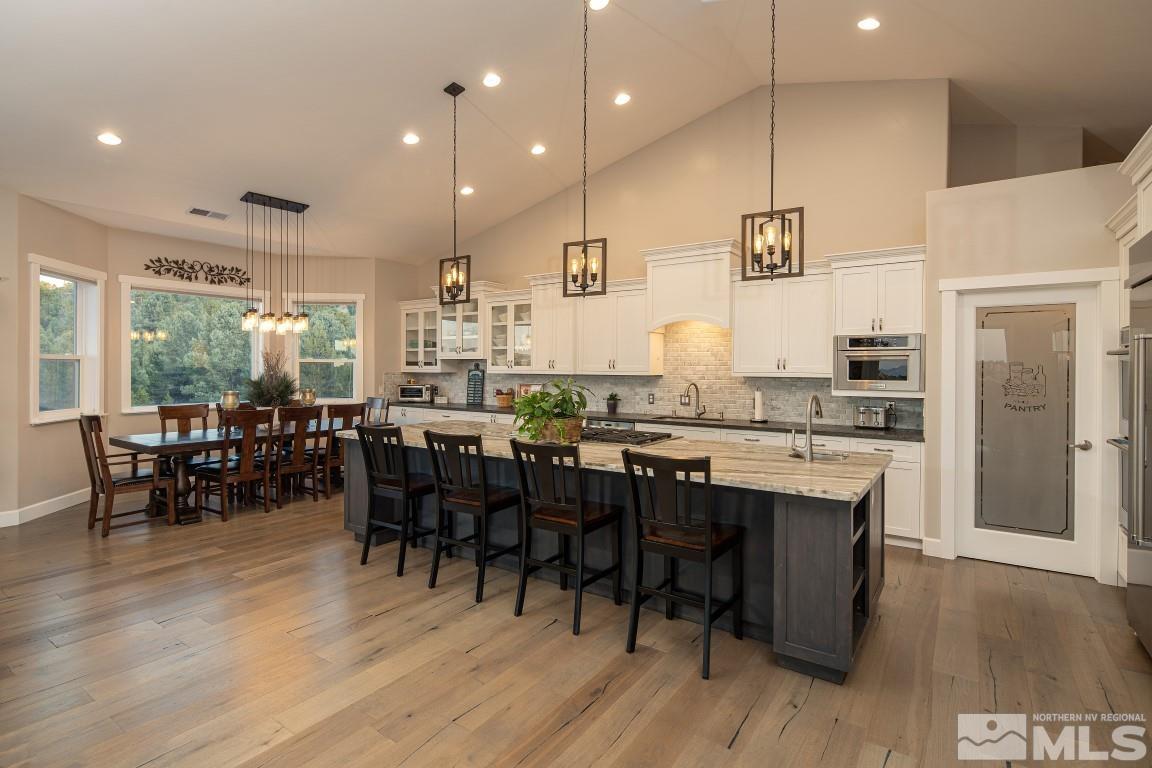4610 Tybo Road Reno, NV 89521 - Photo 1 of 40 a large kitchen with lots of furniture a sink appliances and dining table