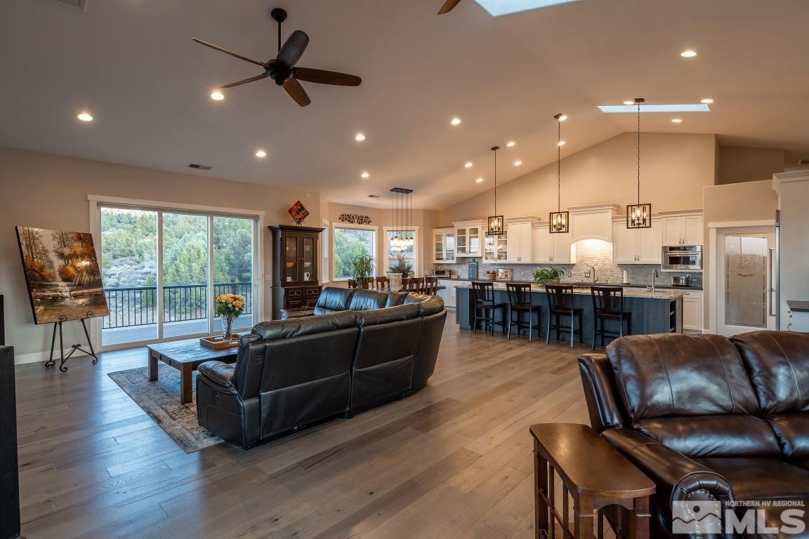 4610 Tybo Road Reno, NV 89521 - Photo 11 of 40 a living room with furniture kitchen area and a wooden floor