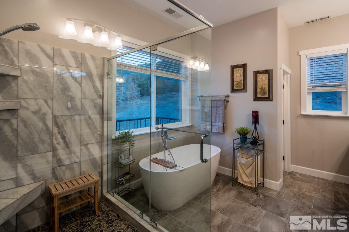 4610 Tybo Road Reno, NV 89521 - Photo 15 of 40 a white bath tub sitting in a bathroom next to a window
