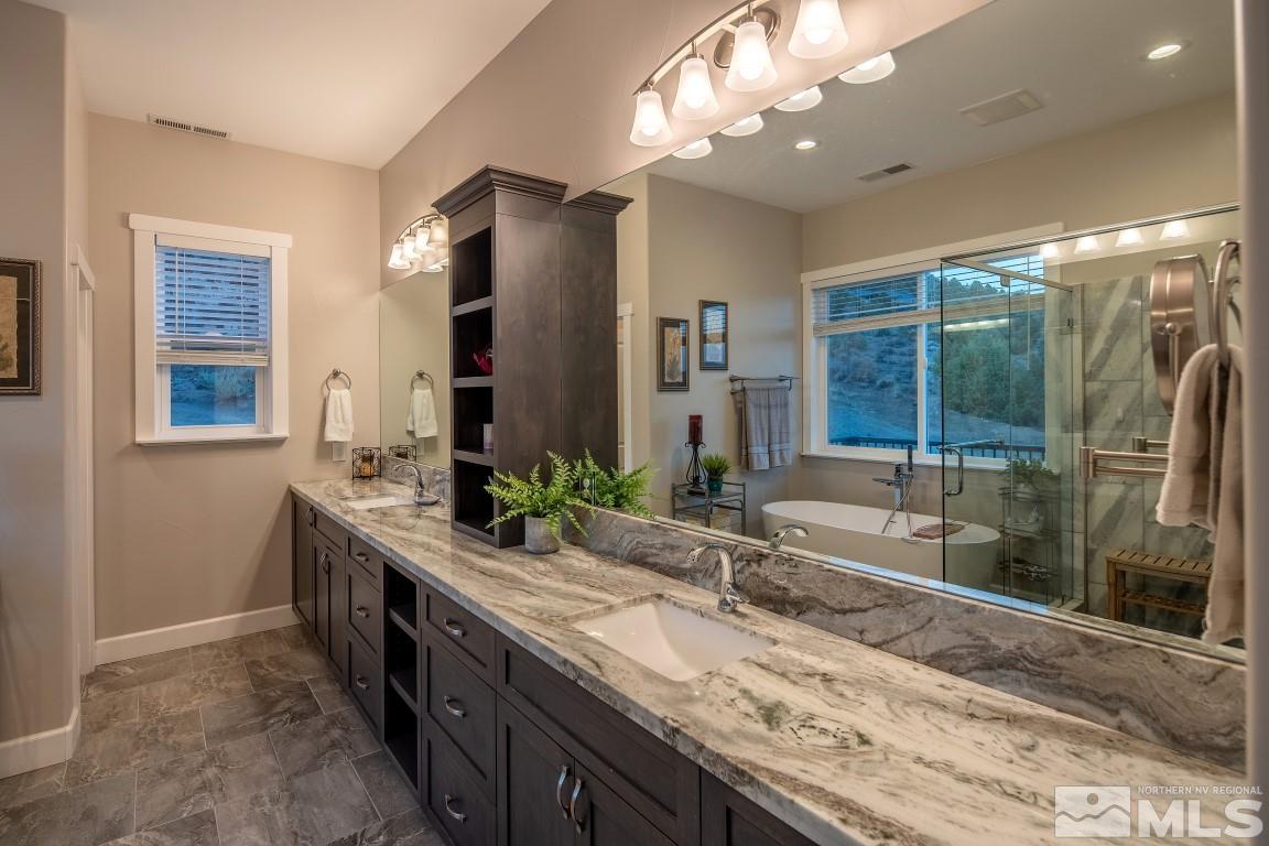 4610 Tybo Road Reno, NV 89521 - Photo 17 of 40 a bathroom with a granite countertop sink and a mirror