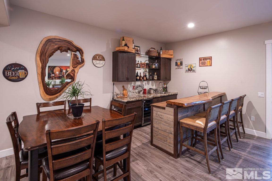 4610 Tybo Road Reno, NV 89521 - Photo 24 of 40 a dining room with furniture and wooden floor