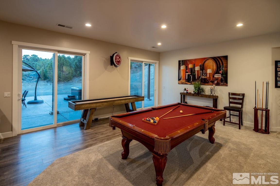 4610 Tybo Road Reno, NV 89521 - Photo 26 of 40 a living room with furniture pool table and a flat screen tv